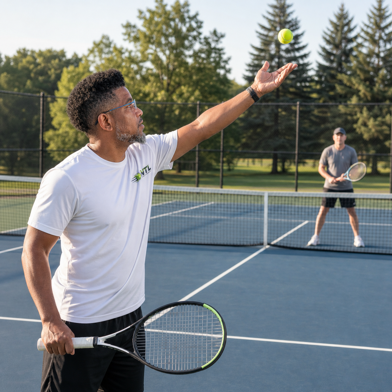 Daniel German demonstrating a tennis serve in Northville